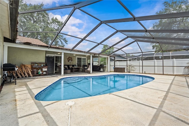 view of pool with a patio area, ceiling fan, and a lanai