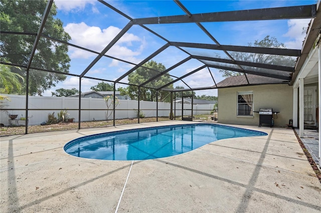 view of swimming pool with a patio, a fenced backyard, a grill, and glass enclosure