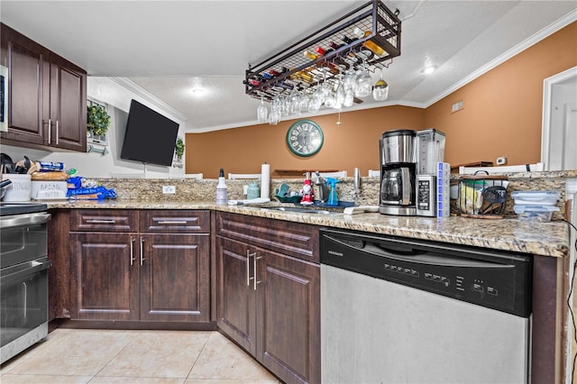 kitchen featuring appliances with stainless steel finishes, crown molding, light tile patterned floors, a textured ceiling, and a sink