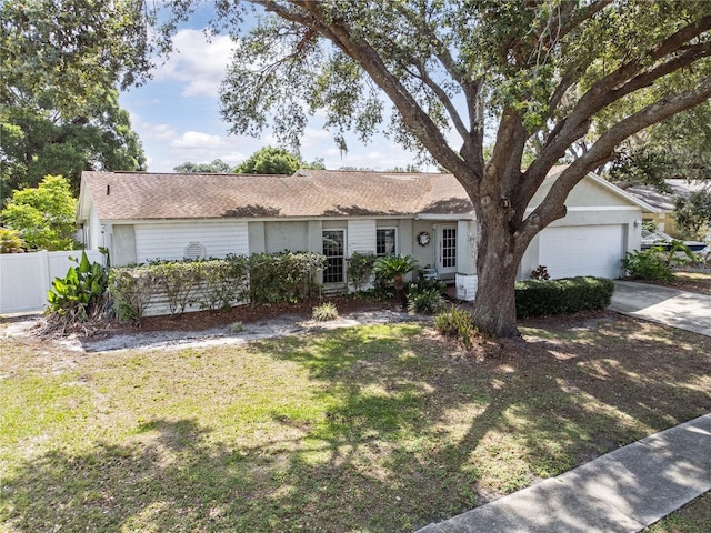 ranch-style home featuring a garage, driveway, and stucco siding