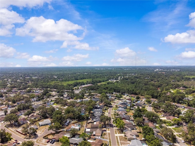 aerial perspective of suburban area featuring a heavily wooded area