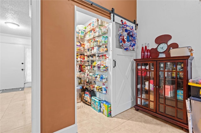 4120 Tyndale Dr, Brandon, FL 33511 - interior space with a textured ceiling, tile patterned flooring, and a barn door