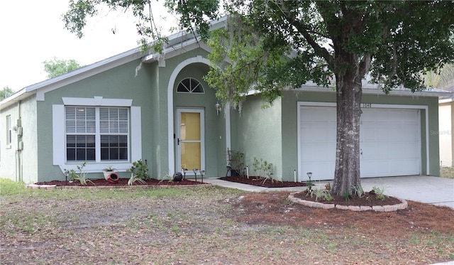 1048 Winding Water Way, Clermont, FL 34714 - view of front of home with a garage, stucco siding, and driveway