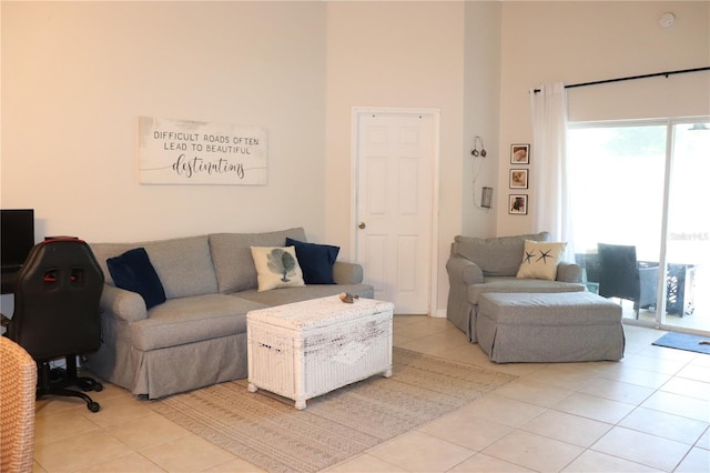 1048 Winding Water Way, Clermont, FL 34714 - living room featuring light tile patterned floors, a high ceiling, and plenty of natural light