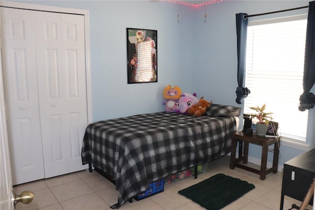 1048 Winding Water Way, Clermont, FL 34714 - bedroom with multiple windows, tile patterned floors, and a closet
