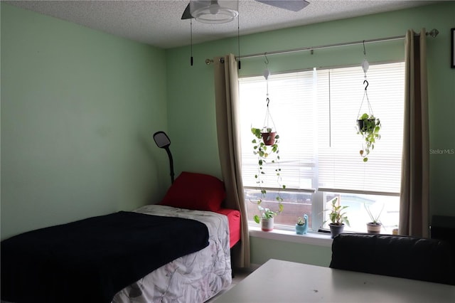 1048 Winding Water Way, Clermont, FL 34714 - bedroom featuring multiple windows, a textured ceiling, and ceiling fan