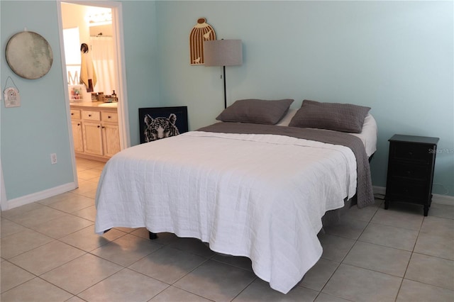 1048 Winding Water Way, Clermont, FL 34714 - bedroom featuring light tile patterned flooring, baseboards, and ensuite bath