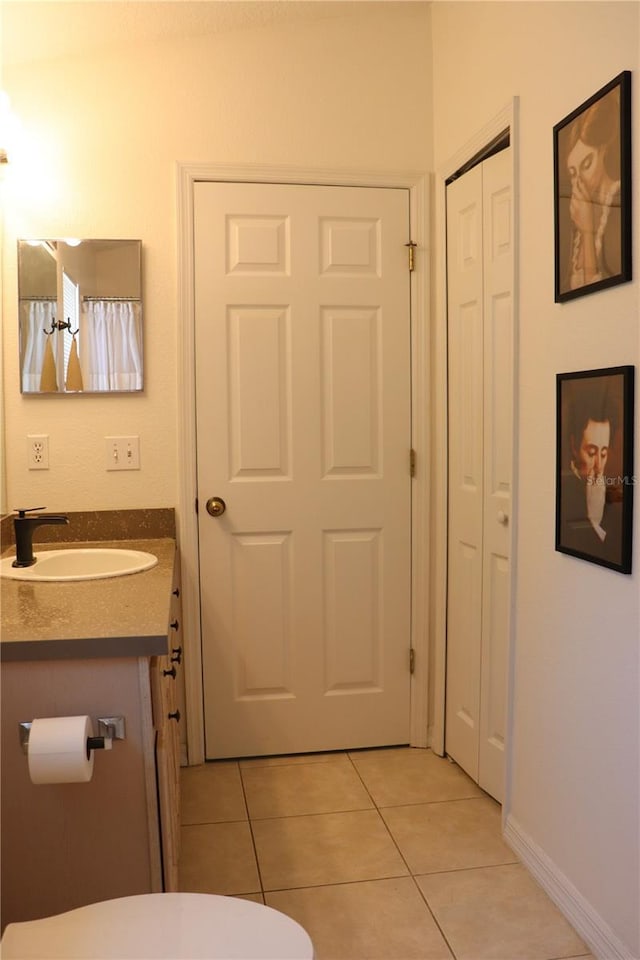 1048 Winding Water Way, Clermont, FL 34714 - bathroom with tile patterned floors, toilet, vanity, and a closet
