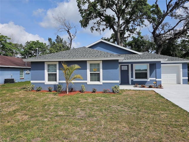 view of front facade with an attached garage, a front yard, stucco siding, and central AC unit