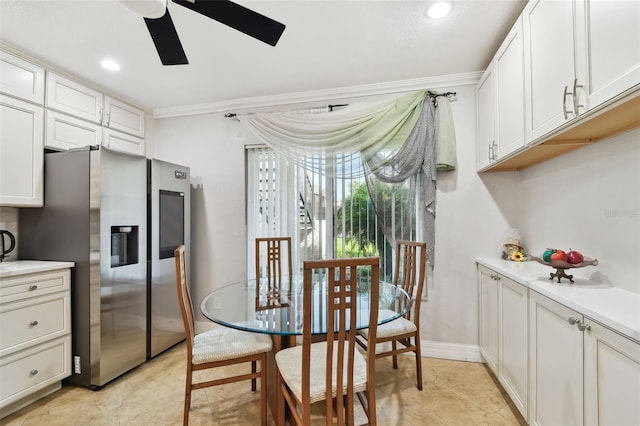 1801 E Lake Rd Unit 3A, Palm Harbor, FL 34685 - kitchen featuring stainless steel fridge, ceiling fan, crown molding, light countertops, and white cabinets