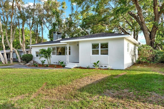 1352 Parkwood St, Clearwater, FL 33755 - single story home with a front yard and a chimney