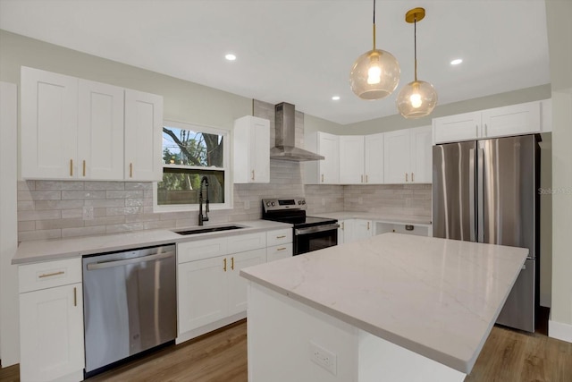 1352 Parkwood St, Clearwater, FL 33755 - kitchen with stainless steel appliances, wall chimney range hood, a sink, a center island, and tasteful backsplash