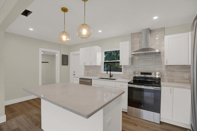 1352 Parkwood St, Clearwater, FL 33755 - kitchen with appliances with stainless steel finishes, a sink, wall chimney exhaust hood, decorative backsplash, and a kitchen island