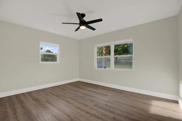 1352 Parkwood St, Clearwater, FL 33755 - unfurnished room with wood finished floors, baseboards, and ceiling fan