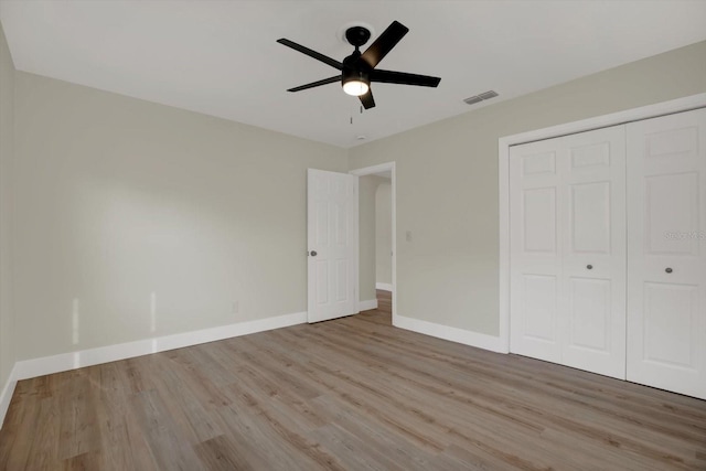 1352 Parkwood St, Clearwater, FL 33755 - unfurnished bedroom with wood finished floors, baseboards, a closet, and ceiling fan