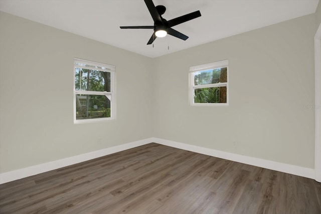 1352 Parkwood St, Clearwater, FL 33755 - spare room featuring plenty of natural light, wood finished floors, baseboards, and a ceiling fan