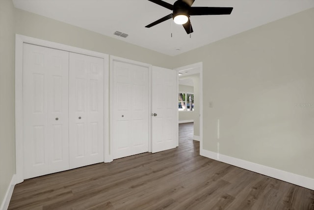 1352 Parkwood St, Clearwater, FL 33755 - unfurnished bedroom featuring wood finished floors, baseboards, and ceiling fan