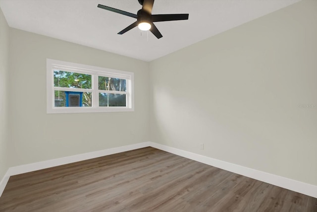 1352 Parkwood St, Clearwater, FL 33755 - spare room with wood finished floors, baseboards, and a ceiling fan