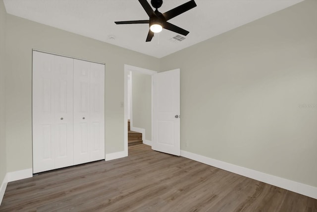 1352 Parkwood St, Clearwater, FL 33755 - unfurnished bedroom featuring wood finished floors, baseboards, a closet, and ceiling fan