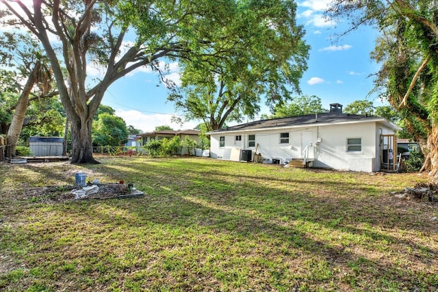 1352 Parkwood St, Clearwater, FL 33755 - view of yard featuring entry steps and central AC unit