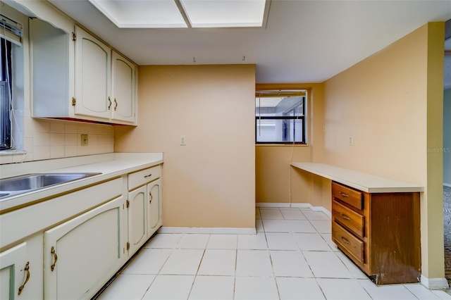 1249 Abbey Crescent Ln, Clearwater, FL 33759 - kitchen with light countertops, baseboards, and decorative backsplash