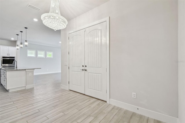 8421 Ivy Stark Blvd, Wesley Chapel, FL 33545 - foyer entrance with a chandelier, light wood-style flooring, baseboards, and recessed lighting