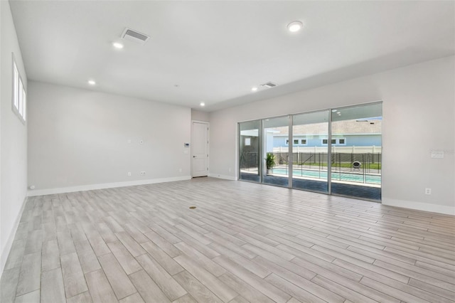 8421 Ivy Stark Blvd, Wesley Chapel, FL 33545 - unfurnished room with light wood-type flooring, baseboards, and recessed lighting