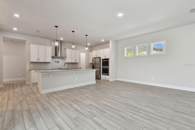8421 Ivy Stark Blvd, Wesley Chapel, FL 33545 - kitchen featuring wall chimney exhaust hood, stainless steel appliances, recessed lighting, a breakfast bar, and baseboards