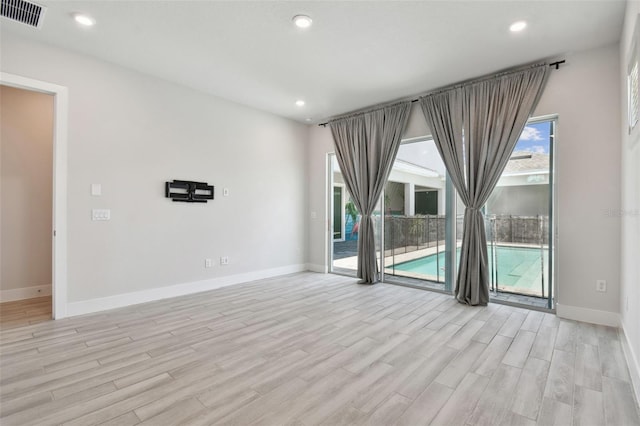 8421 Ivy Stark Blvd, Wesley Chapel, FL 33545 - spare room with light wood-style flooring, baseboards, and recessed lighting