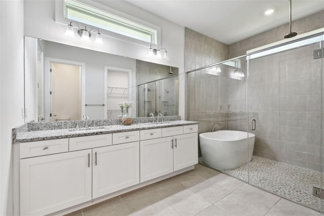 8421 Ivy Stark Blvd, Wesley Chapel, FL 33545 - full bathroom with a shower stall, double vanity, and a freestanding tub