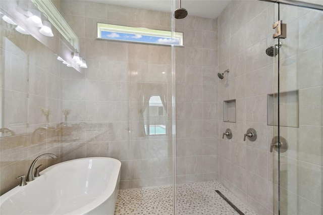 8421 Ivy Stark Blvd, Wesley Chapel, FL 33545 - full bath featuring a stall shower, a freestanding tub, a sink, and tile walls