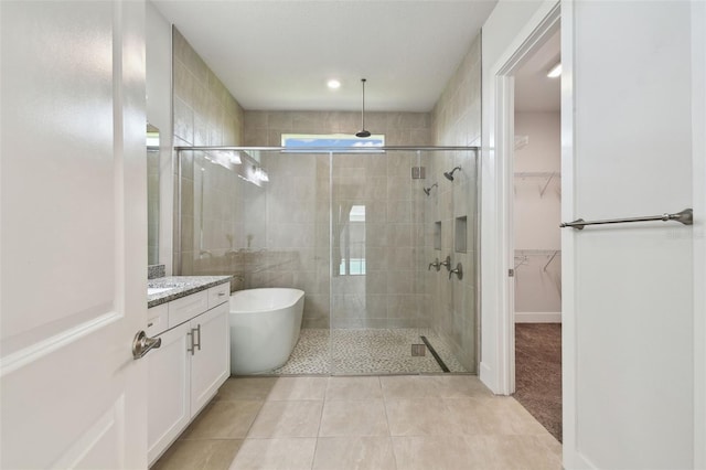8421 Ivy Stark Blvd, Wesley Chapel, FL 33545 - full bath with a stall shower, a freestanding bath, tile patterned flooring, and vanity
