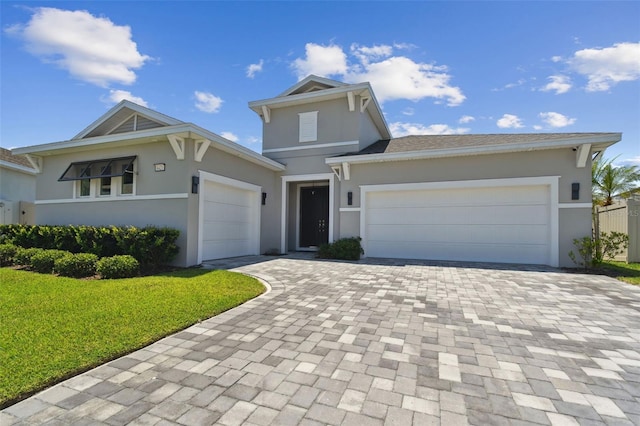 8421 Ivy Stark Blvd, Wesley Chapel, FL 33545 - view of front of home with an attached garage, stucco siding, driveway, and a front lawn