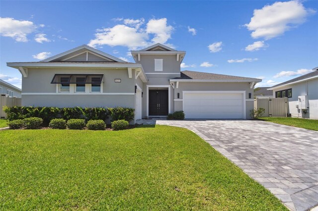 8421 Ivy Stark Blvd, Wesley Chapel, FL 33545 - view of front of home with stucco siding, decorative driveway, a garage, and a gate