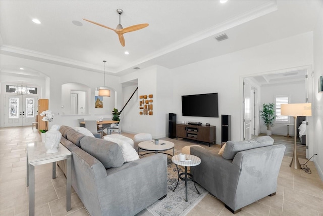 1416 Via Verdi Dr, Palm Harbor, FL 34683 - living room with arched walkways, stairway, a raised ceiling, a ceiling fan, and crown molding