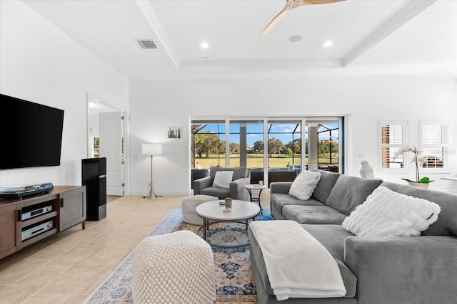 1416 Via Verdi Dr, Palm Harbor, FL 34683 - living room with ceiling fan, a tray ceiling, light tile patterned flooring, and recessed lighting