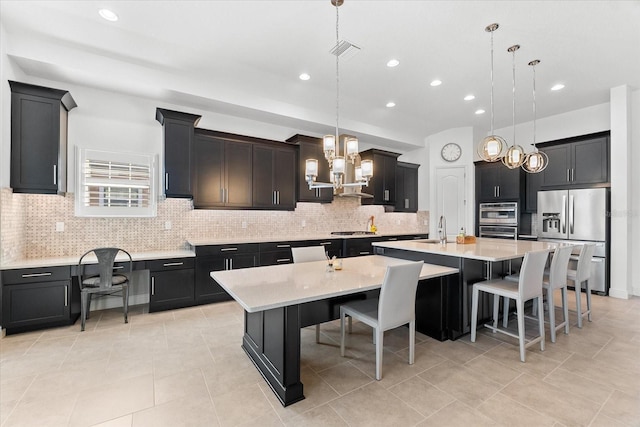 1416 Via Verdi Dr, Palm Harbor, FL 34683 - kitchen with stainless steel appliances, a spacious island, a chandelier, light countertops, and recessed lighting
