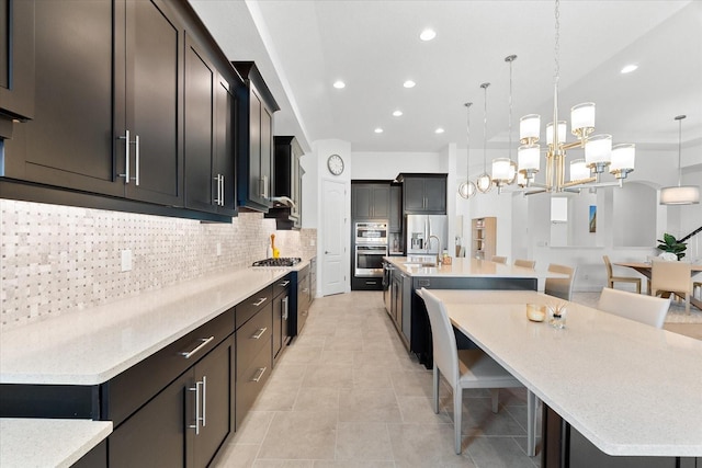 1416 Via Verdi Dr, Palm Harbor, FL 34683 - kitchen featuring a large island, recessed lighting, decorative backsplash, a breakfast bar area, and pendant lighting