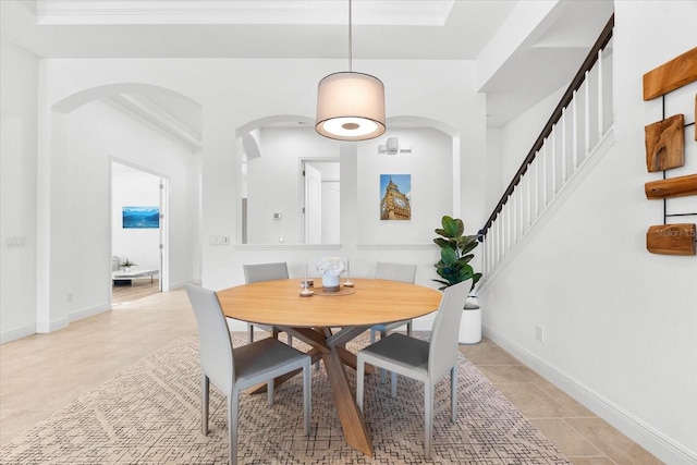 1416 Via Verdi Dr, Palm Harbor, FL 34683 - dining space with ornamental molding, stairs, arched walkways, and light tile patterned floors