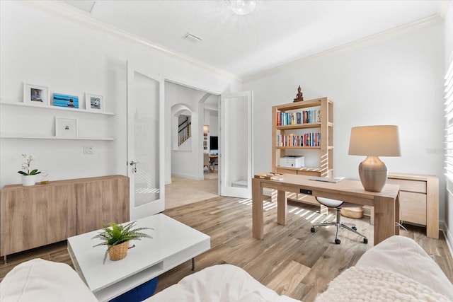 1416 Via Verdi Dr, Palm Harbor, FL 34683 - office area with crown molding, arched walkways, and light wood-style flooring