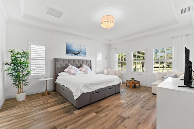 1416 Via Verdi Dr, Palm Harbor, FL 34683 - bedroom with a tray ceiling, light wood finished floors, ornamental molding, and a chandelier