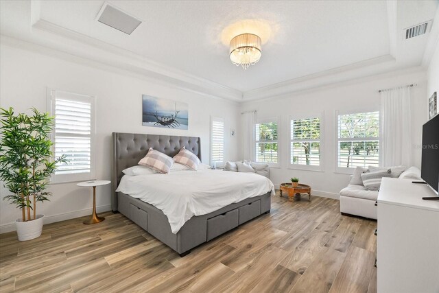 1416 Via Verdi Dr, Palm Harbor, FL 34683 - bedroom with a raised ceiling, multiple windows, light wood-style floors, and ornamental molding