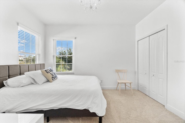 1416 Via Verdi Dr, Palm Harbor, FL 34683 - bedroom featuring carpet flooring, a closet, and a chandelier