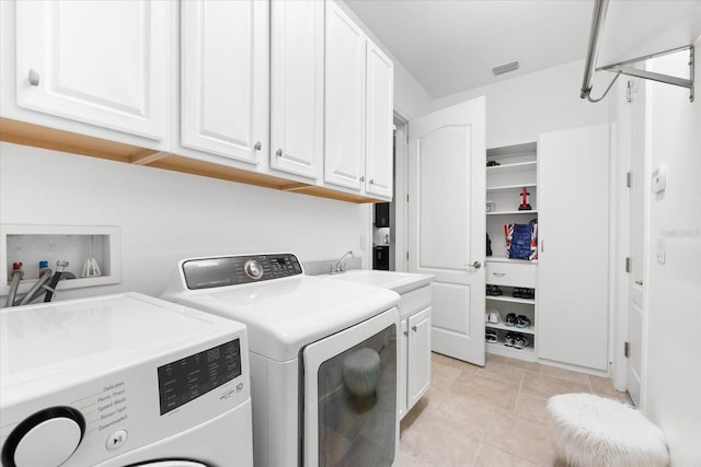 1416 Via Verdi Dr, Palm Harbor, FL 34683 - laundry area with washing machine and clothes dryer, cabinet space, and light tile patterned floors