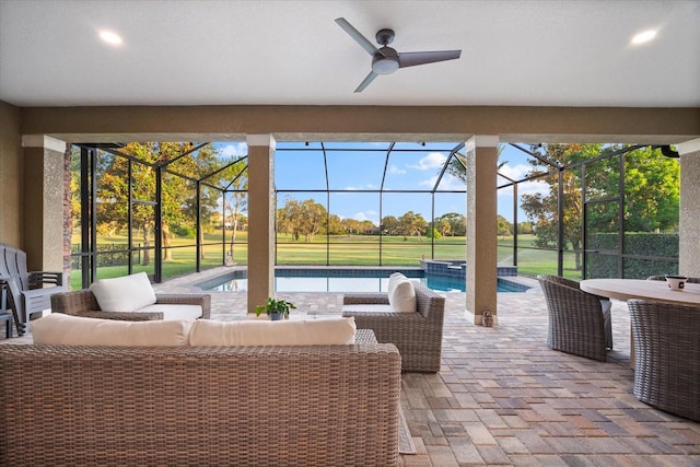 1416 Via Verdi Dr, Palm Harbor, FL 34683 - view of patio featuring an outdoor living space, a ceiling fan, glass enclosure, view of golf course, and a pool with connected hot tub