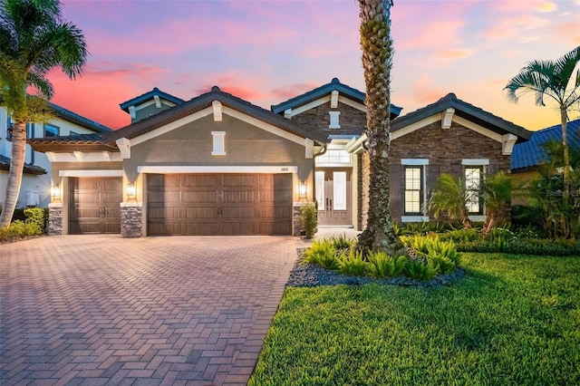 1416 Via Verdi Dr, Palm Harbor, FL 34683 - craftsman house with stone siding, an attached garage, decorative driveway, and stucco siding