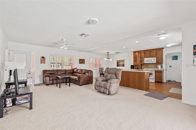 603 Royal Crest Dr, Brandon, FL 33511 - living area with light carpet, a textured ceiling, a ceiling fan, baseboards, and recessed lighting