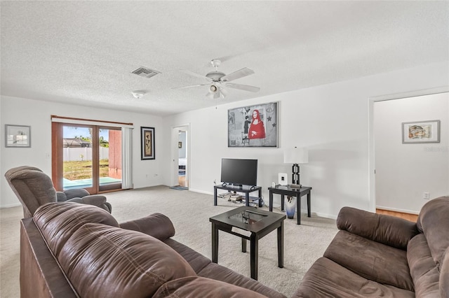 603 Royal Crest Dr, Brandon, FL 33511 - living room featuring light carpet, a ceiling fan, baseboards, and a textured ceiling