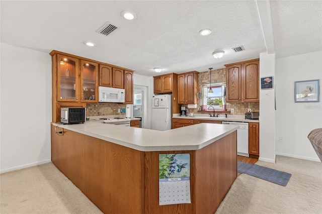 603 Royal Crest Dr, Brandon, FL 33511 - kitchen with white appliances, light colored carpet, light countertops, brown cabinetry, and recessed lighting