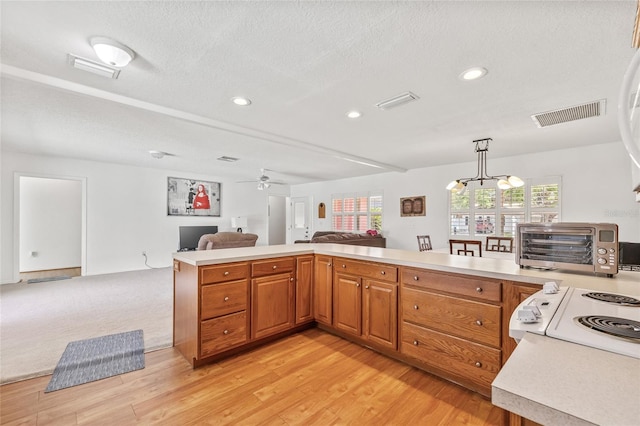 603 Royal Crest Dr, Brandon, FL 33511 - kitchen featuring open floor plan, light countertops, recessed lighting, brown cabinets, and light wood-type flooring